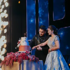 The cake-cutting ceremony, illuminated by sparklers, during a glamorous Sangeet night. We ensure every key moment is celebrated in style.