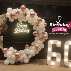 Celebrating 60 in style. This elegant setup features our marquee numbers next to a white and rose gold balloon hoop, accented with dried palm leaves.