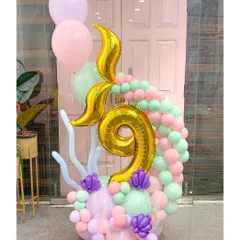 A magical mermaid-themed arrangement for a 9th birthday. The golden mermaid tail and number '9' are surrounded by a pastel wave of balloons, perfect for any child who dreams of the sea.