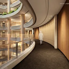 The curved corridors of the Palais Royale atrium showcase a seamless blend of structural ingenuity and aesthetic sophistication. Lined with rich wood paneling and overlooking the vast central space, every corner is designed to be an experience in quiet luxury.