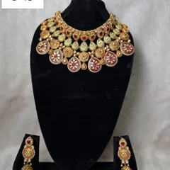 My rental set B-16 features a warm, antique gold tone with red meenakari work. This choker and jhumka set is perfect for pairing with traditional silk sarees.