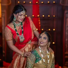 I love styling friends and sisters for events. Here, two friends are sharing a happy moment, one wearing a grand emerald and polki set and the other in a classic temple jewellery look, both from my collection.