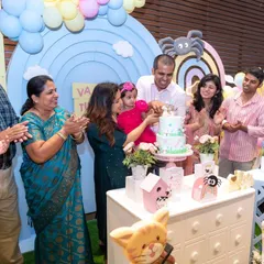 The whole family gathers around for the cake cutting ceremony at a first birthday party. Capturing these multi-generational moments of celebration is what makes small event photography so special for us.