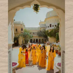 The bride's grand entrance with her family for the Haldi ceremony, framed beautifully by the heritage architecture. A moment of tradition and togetherness.