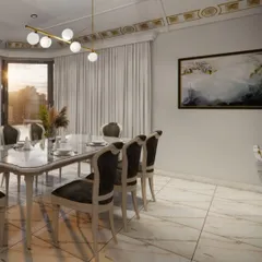 The dining space within a luxurious home, featuring a marble-top table and high-backed upholstered chairs. A modern globe chandelier and gold-accented ceiling trim add a layer of contemporary elegance to the room.