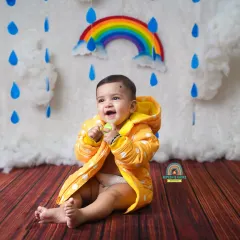 A big, cheerful laugh from this little one during our fun and colorful monsoon-themed mini session.