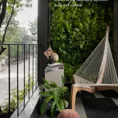 A balcony doesn't have to be an afterthought. Here, a vertical garden and locally sourced Kota stone flooring dissolve the boundary between the built and the natural, creating a serene urban oasis.