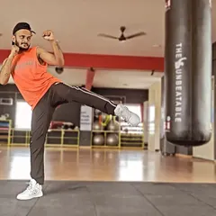 Hear that? That's Strong Nation cheering you on. A powerful side kick, demonstrating the martial arts influence in this high-intensity interval training program.