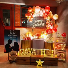 I designed this romantic birthday surprise for Gayathri. The setup features a warm, inviting color palette with a sequin backdrop, a custom silhouette poster, and lots of marquee lights spelling out her name and the word "LOVE" to create a truly personal and heartfelt atmosphere.