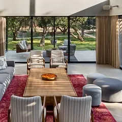 Natural light is our most valued material. In the Mango Orchard House, we designed the living area with expansive glass walls that frame the lush greenery, making the landscape an integral part of the daily living experience.