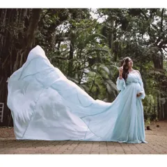 Celebrate your journey to motherhood with a touch of magic. This powder blue maternity gown, with its stunning flowing trail, is perfect for creating ethereal and beautiful memories during your maternity photoshoot.