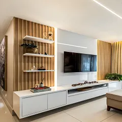 A sleek, contemporary TV unit combining white cabinetry with warm wood fluted panels and integrated LED lighting. This design offers ample storage and a clean aesthetic, making it a stylish centerpiece for any modern living room.
