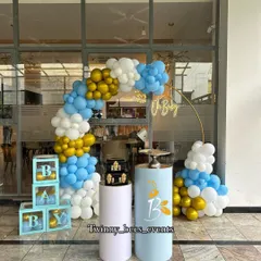 Here is a blue, white, and gold themed baby shower setup we did outdoors. It features a balloon arch, "BABY" display boxes, and matching pedestals, creating a clean and elegant look for welcoming a baby boy.