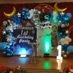 We bring themes to life with custom setups like this space adventure for a first birthday, featuring a personalized backdrop, rocket and planet foil balloons, and a light-up number '1' to mark the special milestone.