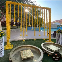 For this outdoor Haldi ceremony, I designed a beautiful backdrop using curtains of fresh marigold flowers. The setup includes traditional brass urlis and ornate chowkis, creating a perfect blend of elegance and festive tradition for the bride's haldi.
