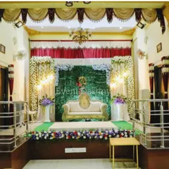 A full view of the green wall stage setup in a party hall. The combination of natural textures and elegant lighting creates a sophisticated atmosphere.