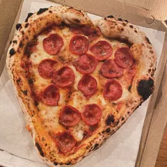 Nothing says "Amore" like a heart-shaped pizza. I love making these for special occasions. This one is a classic pepperoni, fresh from the wood-fired oven with a perfectly leopard-spotted Neapolitan crust.