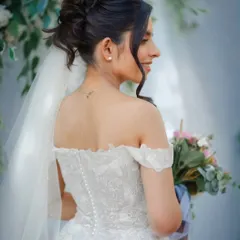 To highlight her stunning neckline, I designed this tossed updo with a statement side-swept hairpiece. Her makeup was clean and glowy, ensuring it lasted all day while looking effortlessly beautiful.