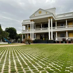 The centerpiece of this property is the vast lawn made of grass pavers, creating a durable yet green surface suitable for events and parking. This design complements the home's neoclassical architecture and provides a sense of scale and elegance.