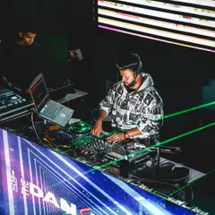 In the zone at The Dansing Bottle. Notice the laptop running Rekordbox alongside the CDJs. I'll teach you how to organize your music library like a pro.