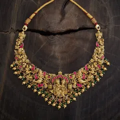 This is a piece I am incredibly proud of, a true example of wearable art. It's a gold-toned temple necklace featuring an intricate depiction of Radha and Krishna, detailed with meenakari enamel in rich pink and green. This handmade choker is for those who appreciate divine motifs and exceptional craftsmanship in their traditional jewellery.