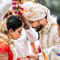 An intimate close-up from a South Indian wedding, capturing the reverence of the ceremony. Our photographers are experienced in various cultural traditions, ensuring we respectfully document the most important details of your day.