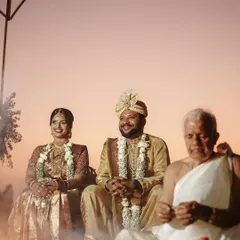 A serene beachside wedding ceremony against a beautiful sunset. We captured this Mangalorean wedding ritual, with the priest and the sacred fire, creating a truly magical and spiritual atmosphere.