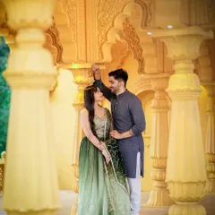 A beautifully framed shot of the couple through ornate pillars at a palace-themed pre-wedding location. This technique adds depth and a sense of intimacy to the portrait.
