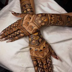 A creative pose showing the beautiful symmetry of our back-hand designs. The peacock and geometric motifs are perfectly mirrored on both hands.
