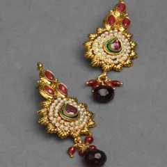 These gold-tone earrings feature a unique design with red stones and a central meenakari detail. They are part of my affordable collection, offering great style for less.