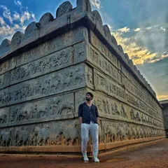 The wall of the Mahanavami Dibba, intricately carved with scenes of royal processions, elephants, and soldiers. Hampi's stories are written in stone.