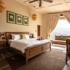 This bedroom at Buransh Terraces is a sanctuary of calm, with a solid wood bed, natural fiber pendants, and a large window seat perfect for watching the changing mountain light. The design is all about tranquility and connection to nature.