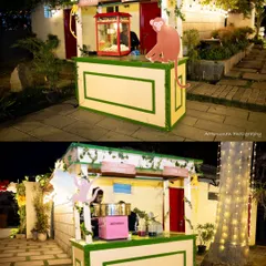 Custom-built food stalls for a jungle-themed event, including a popcorn machine and a cotton candy station, designed to look like charming jungle huts.