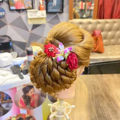 The same student-made hairstyle from a slightly different angle, showing the volume and structure of the updo.