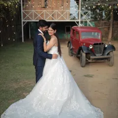 For a timeless and classic pre-wedding shoot, our white lace ball gown is a perfect choice. This gown features intricate detailing and a full skirt with a train, offering a sophisticated bridal look that pairs beautifully with vintage or rustic settings.