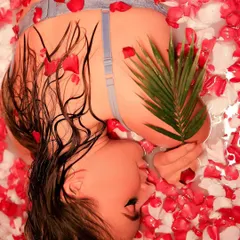 An artistic overhead shot from a milk bath session, using red and white rose petals to create a visually stunning and romantic image.