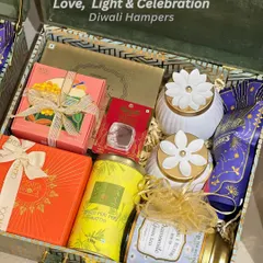 This premium Diwali hamper is packed in a stunning green and blue patterned trunk box. Inside, you'll find luxury chocolates, festive snacks, and beautiful floral-topped candle jars, blending tradition with modern luxury.
