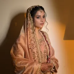 A portrait of the bride, her regal look completed with a traditional passa and maang tikka.