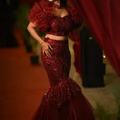 Anusha looking glamorous and confident in her custom red gown.