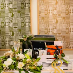 The bespoke bridal gift tray, featuring luxury items from Chanel and Hermès, personalized with the couple's initials. This is where sophistication meets heartfelt sentiment.