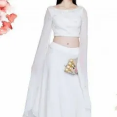 An elegant all-white crop top and skirt set featuring flared georgette sleeves and delicate pearl embroidery. This minimalist yet chic ensemble is perfect for a sophisticated daytime event or a themed party.