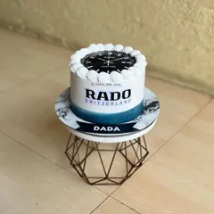 A cake designed for a watch enthusiast, featuring the Rado brand logo and a watch face. This is a great example of a personalized cake for an adult.