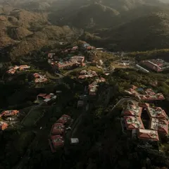 A wide, establishing shot of the ITC Mementos resort in Udaipur. This aerial perspective is perfect for showing potential guests the scale of the property and its beautiful natural surroundings.