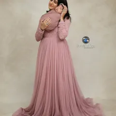A mother's first embrace is a memory to cherish forever. I provide a selection of beautiful gowns, like this flowing pink one, for moms to wear during their newborn family portraits, creating timeless and elegant images.