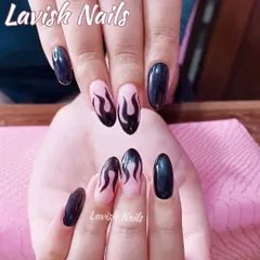 Edgy and cool, these almond-shaped nails feature a black flame design hand-painted over a natural pink base.