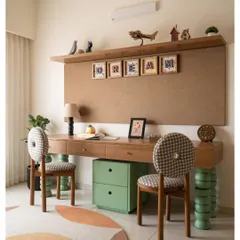 A dedicated study area for two, with a floating wooden desk and quirky chairs supported by green totem-like legs. The large corkboard is perfect for pinning up artwork and dreams.