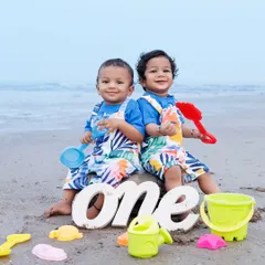 A first birthday for twins calls for a special celebration on the beach. We brought along some simple props like sand toys and the 'one' sign to mark this incredible milestone.