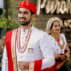 A creative portrait focusing on the groom in the foreground, with his bride softly blurred in the background. This shot highlights his anticipation and the love that awaits him.