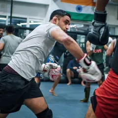 A focused shot of a fighter throwing a punch during a sparring session. This is where technique is tested under pressure.