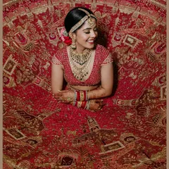 A bride's portrait is more than a photo; it's a timeless piece of art. Here, we captured Kriti in her magnificent red lehenga, showcasing the intricate details of her attire and the joyful anticipation in her smile.